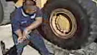 HOW TO BREAK DOWN A 23525 LOADER TIRE BY HAND [upl. by Cutlerr831]