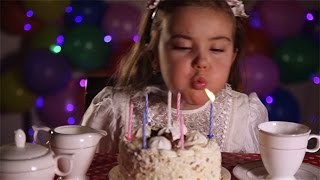 Little Girl Blowing Out The Candles of Birthday Cake Stock Footage [upl. by Mcmaster]