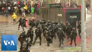 Protesters Face Water Cannon Tear Gas in Colombia Protest [upl. by Llednav]