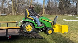 Loading a John Deere X590 with a snow blower and tire chains on a trailer [upl. by Kenna174]