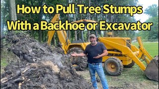 Using a Backhoe to Pull Tree Stumps [upl. by Ahsieit591]