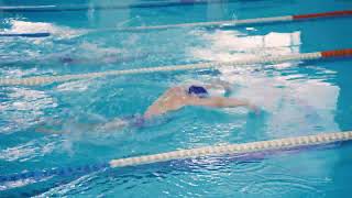 A young man and woman swim butterfly style in a swimming pool Taking care of your health cardio [upl. by Koerlin]