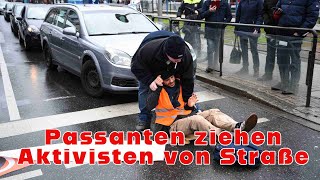 Aktivisten kleben sich auf Fahrbahn  Passanten ziehen zwei davon von der Straße [upl. by Anoo834]