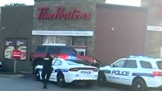 Wild getaway attempt at Tim Hortons drivethru  Suspect drives over police cruiser [upl. by Bevan]