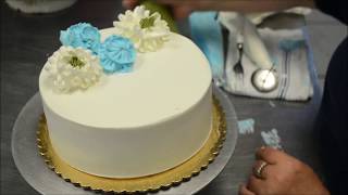 Cake decorating tutorial on how to design cream flowers on a birthday cake [upl. by Eimmis50]