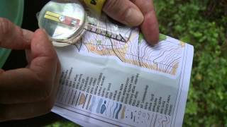 Taking a bearing using a compass while orienteering [upl. by Hcra665]