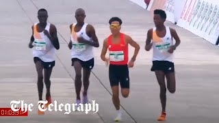 Runners appear to let Chinese contestant win Beijing halfmarathon [upl. by Lotty428]