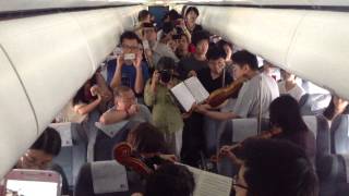 Philadelphia Orchestra musicians perform on flight waiting on Beijing tarmac [upl. by Schurman94]