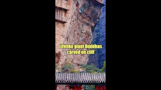 Lifelike giant Buddhas carved on cliff in Chinas Gansu [upl. by Annaeerb107]