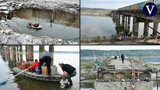 La destrucción de un puente en Járkiv obliga a los residentes ucranianos a cruzar el río en bote [upl. by Pelagia]