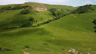 Aerial View of Rolling Green Hills and Lush Forest in a Mountainous Region [upl. by Devin703]