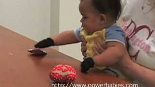 Baby picking up objects using Grabby Gloves from powerbabiescom [upl. by Hara]