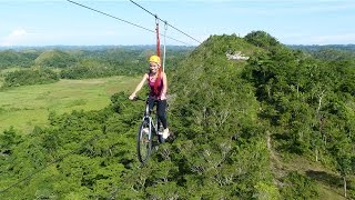 Tourists Ride Bicycle Over Zipline [upl. by Oiramat757]